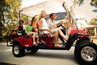 Put-in-Bay-Golf Golf Carts = Photo of a family driving a Put-in-Bay golf cart Rental.